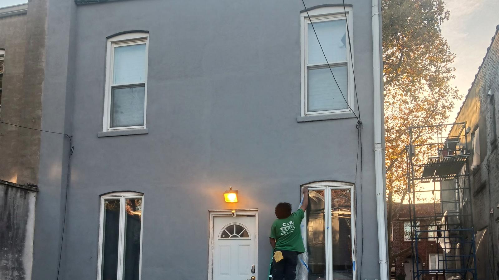 C&R crew finishing the exterior of a house at sunset